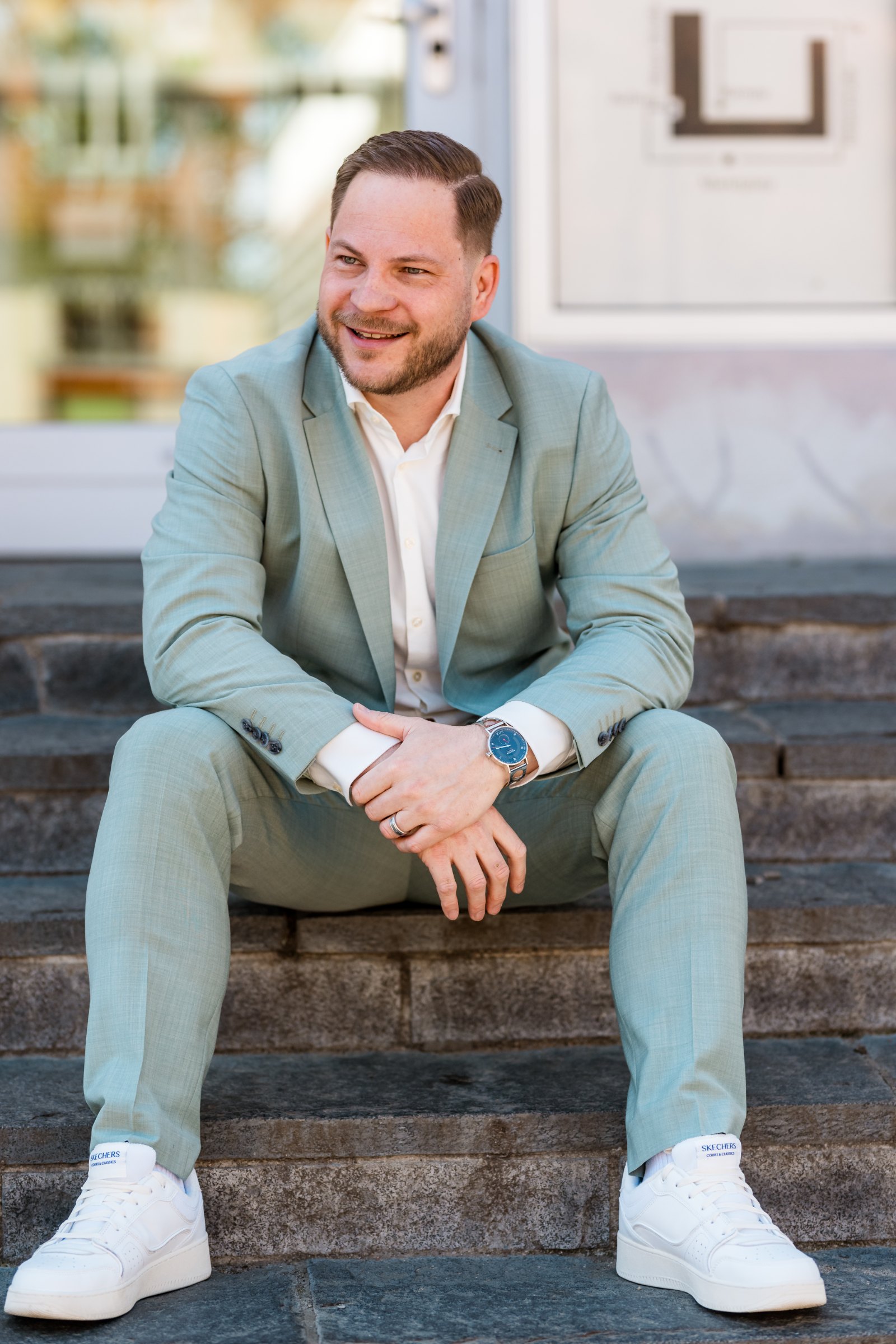 Stefan Gerdts, Gründer und Geschäftsführer von yavi solutions, sitzt lachend auf einer Treppe